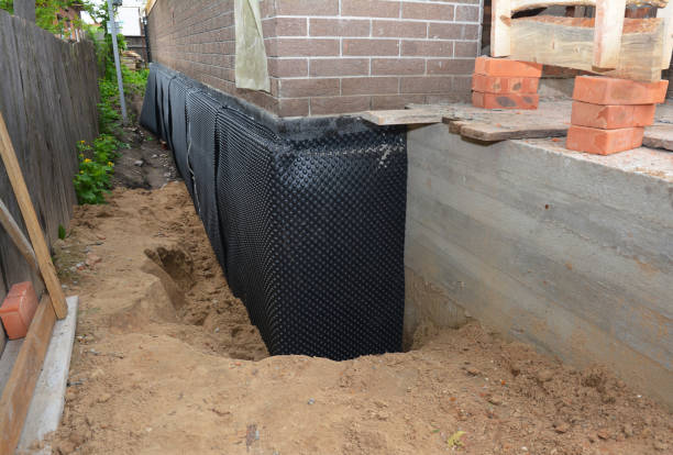 SJ Waterproofing Pros technician performing targeted Basement Waterproofing assessment in Nichols, WI